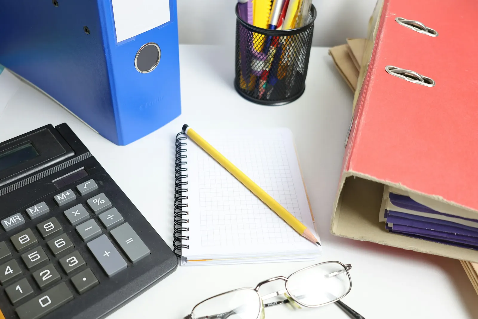 Ledgers and a laptop on a partner's desk