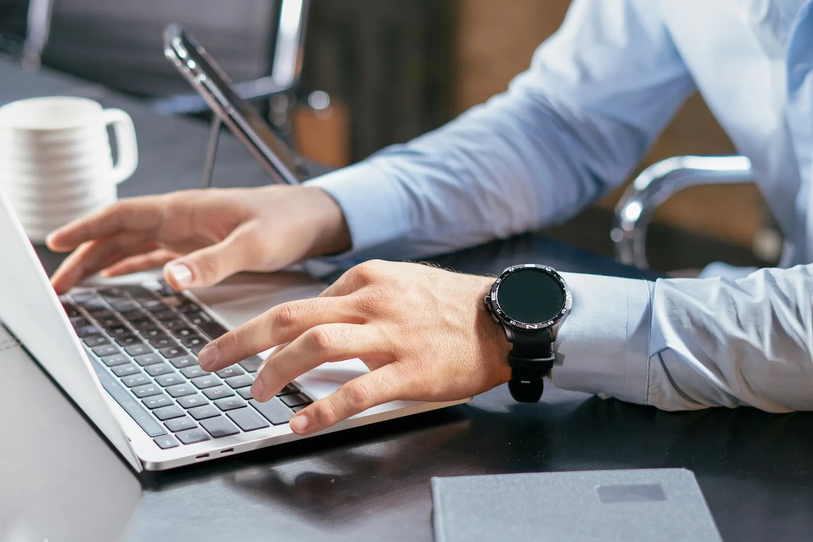 A consultant working at a laptop in a bright office